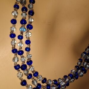 Glass beaded 56" long blue and clear necklace